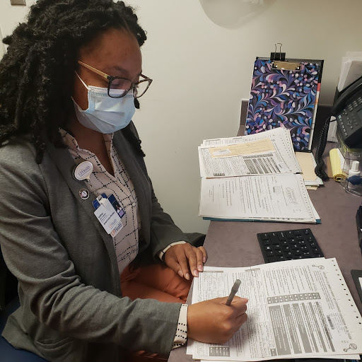 Sydney sitting at a desk while completing Healthy Start screenings