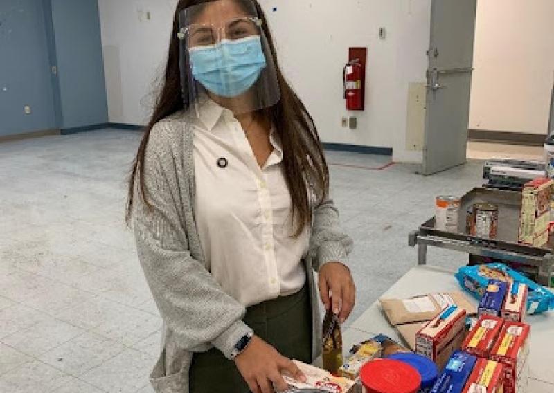 NHC Member Taylor conducting a holiday food drive for TCC patients in the space that is now the Food Pharmacy.