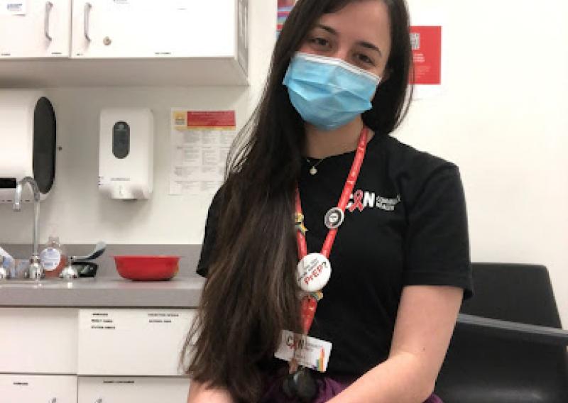 Marie Feliu is pictured sitting in an exam room where she conducts HIV, Hep C, and  STI testing. 