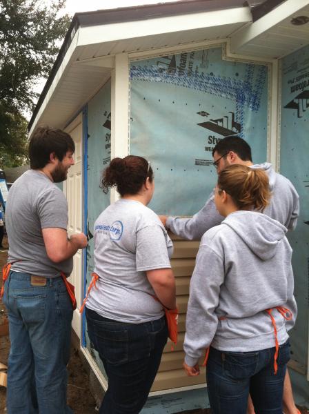 Picture of members installing siding