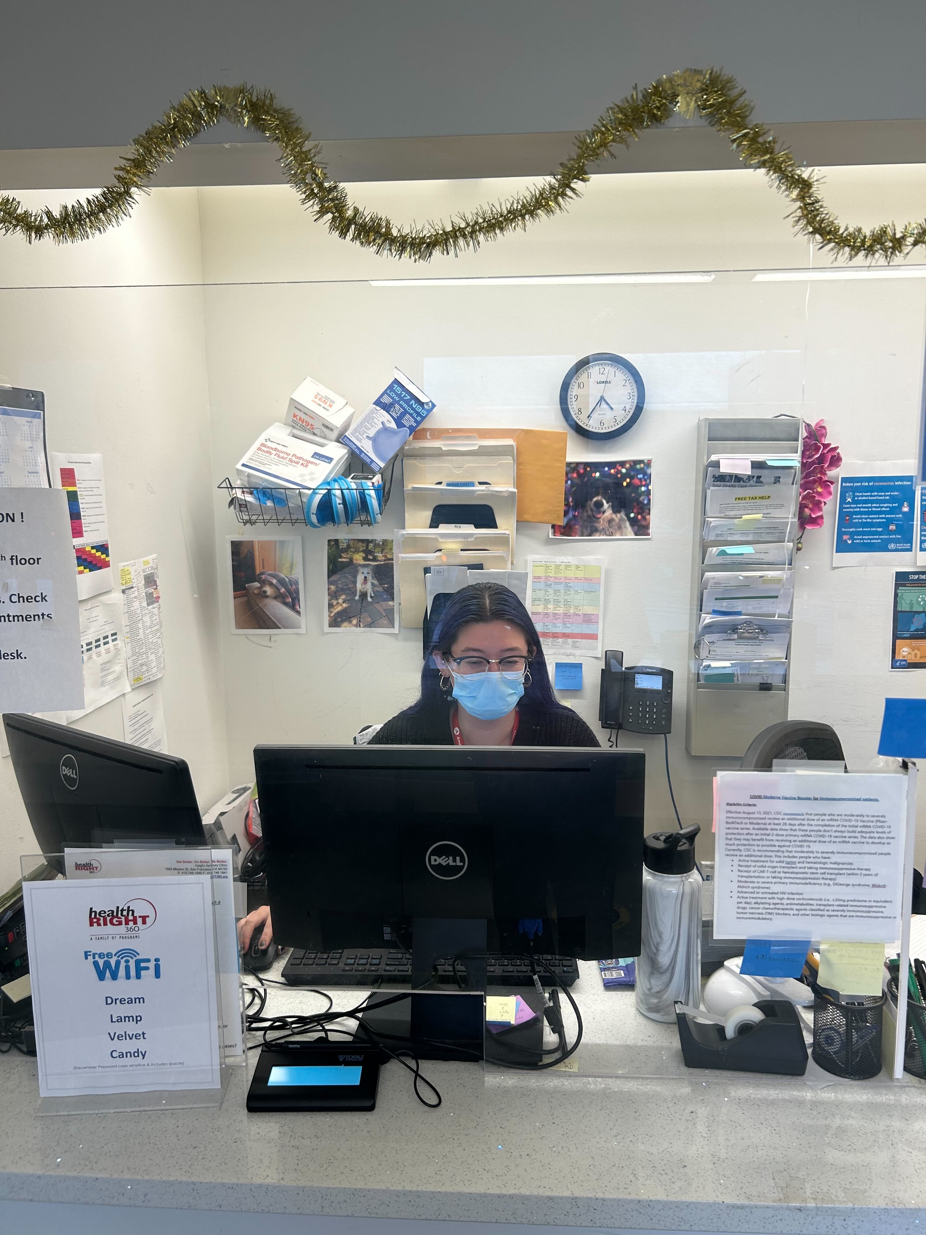 Megan is seen sitting at a desk, facing her monitor. 