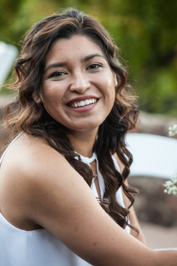 Maria Hower is seen facing the camera and smiling. 